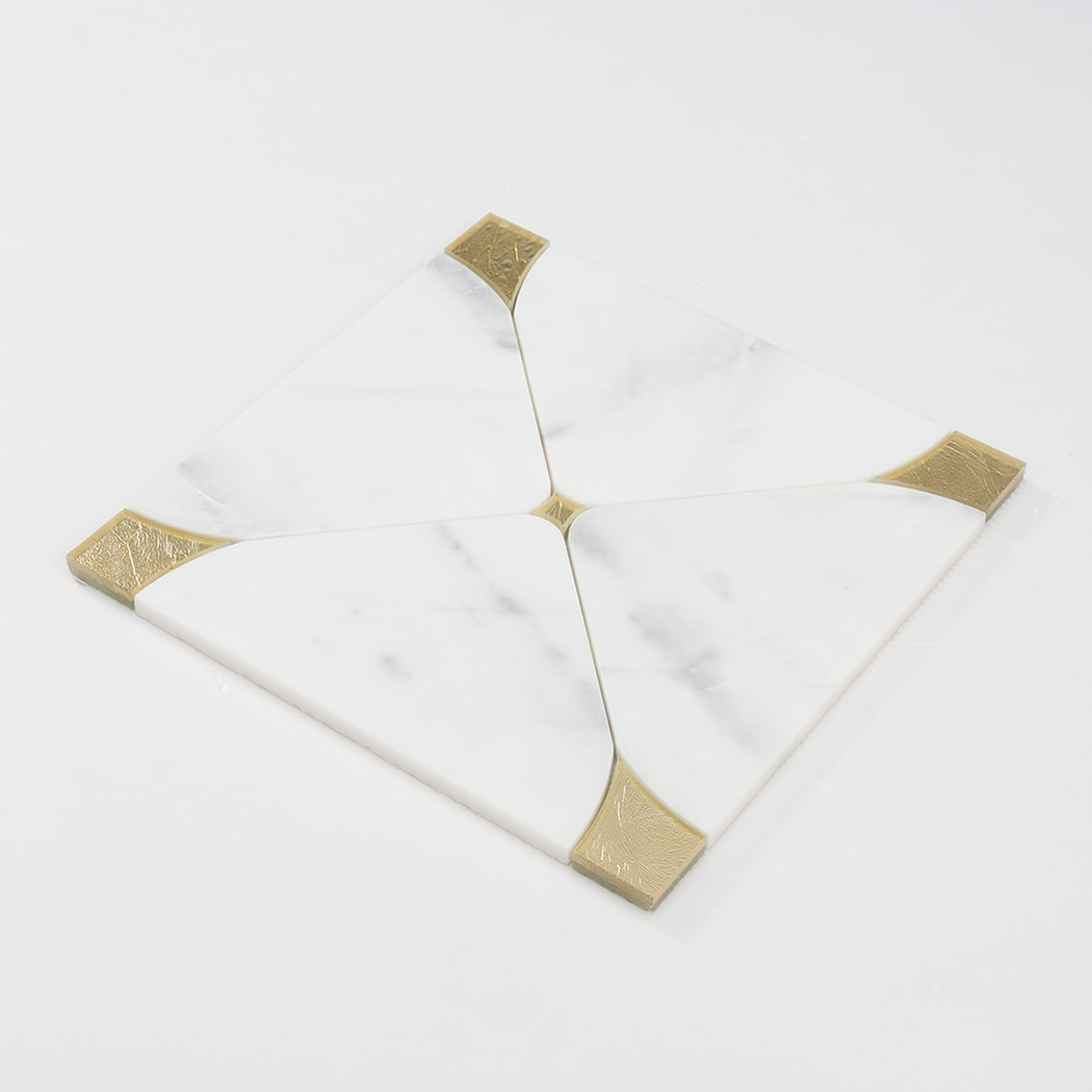 Angled view of white marble square mosaic tile with gold glass corner inserts