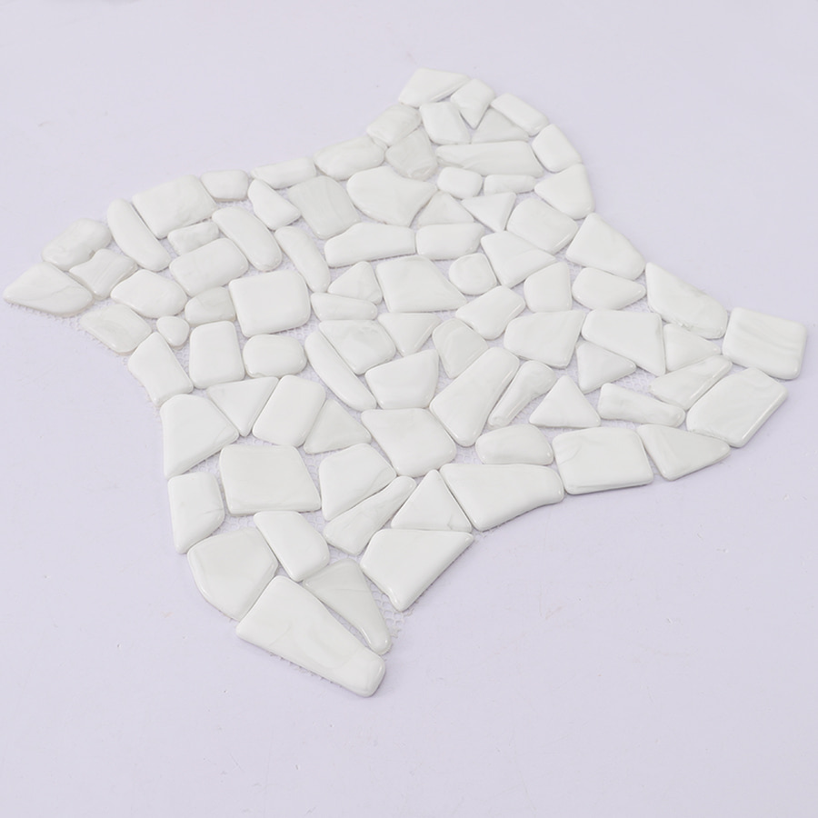 Angled view of white pebble shaped mosaic tile sheet