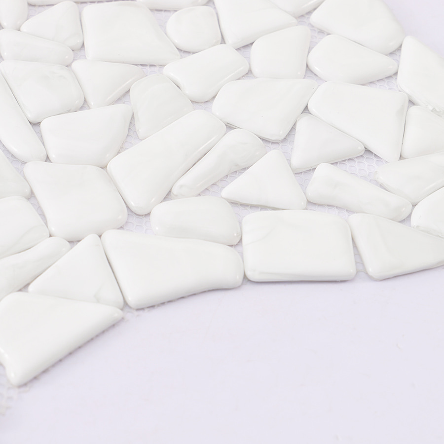 Edge view of white pebble shaped mosaic tile sheet