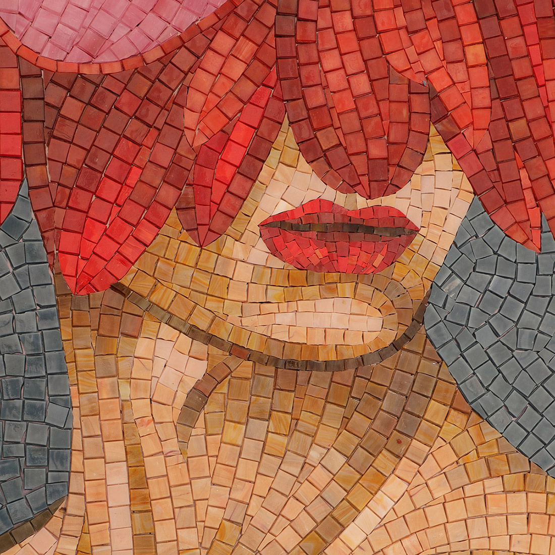 Detailed glass mosaic of woman lips with red hair and soft skin tones