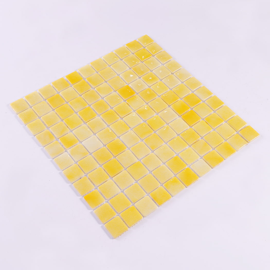 Angled view of yellow recycled glass square mosaic tile sheet