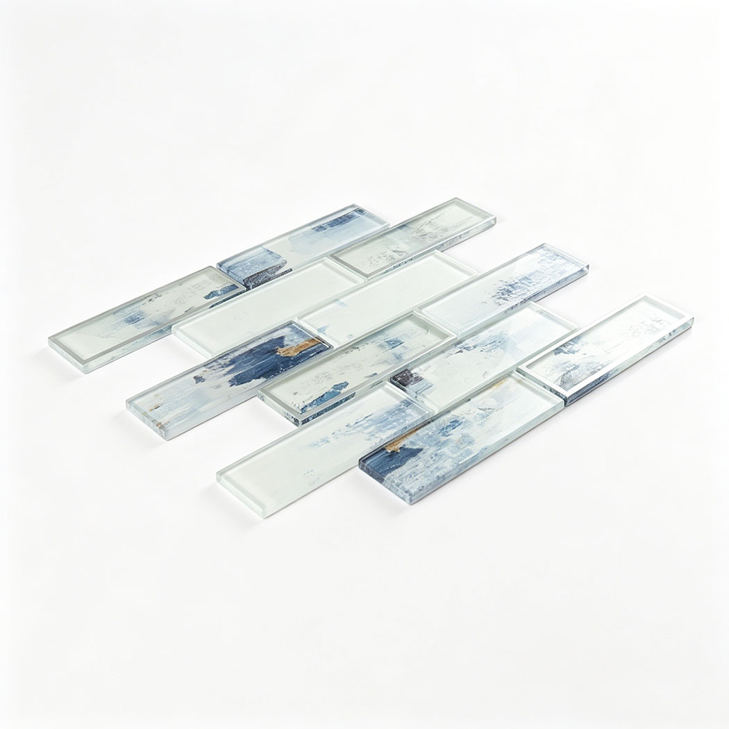 Angled glass subway tile sample with soft blue brush pattern and silver framed accents