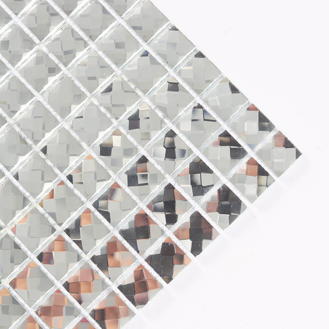Close-up angled view showing the faceted edges of silver mirror glass mosaic tiles.