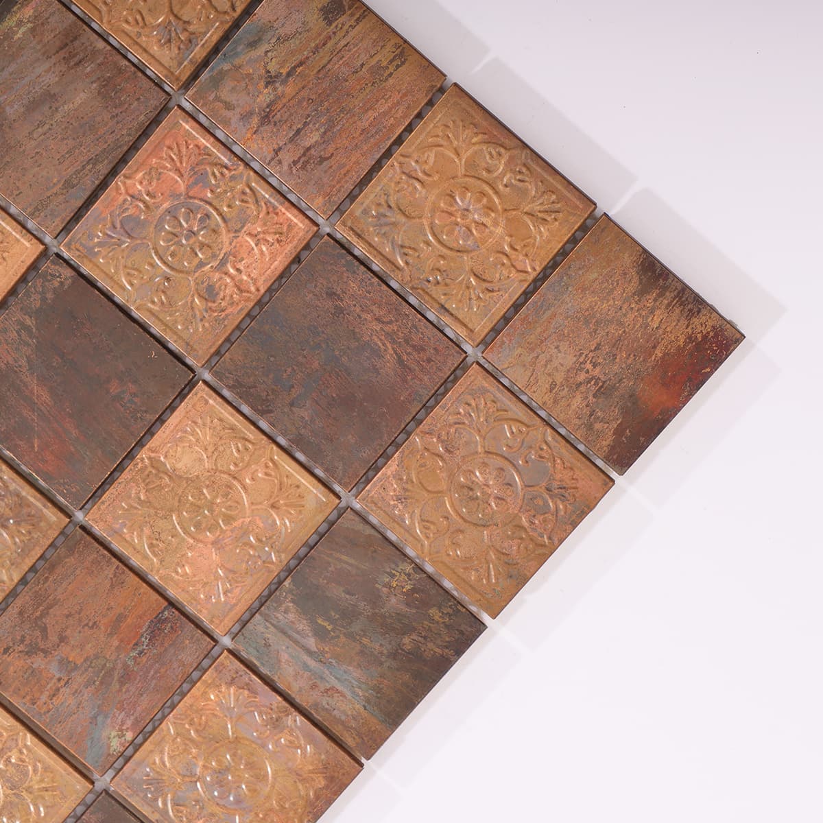 Closeup of copper mosaic tile with detailed rose floral design