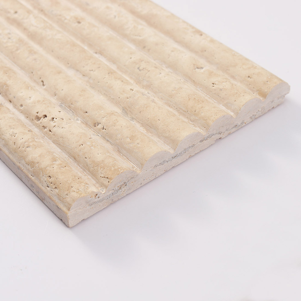 : Angled view highlighting the scalloped profile of a textured beige travertine tile.