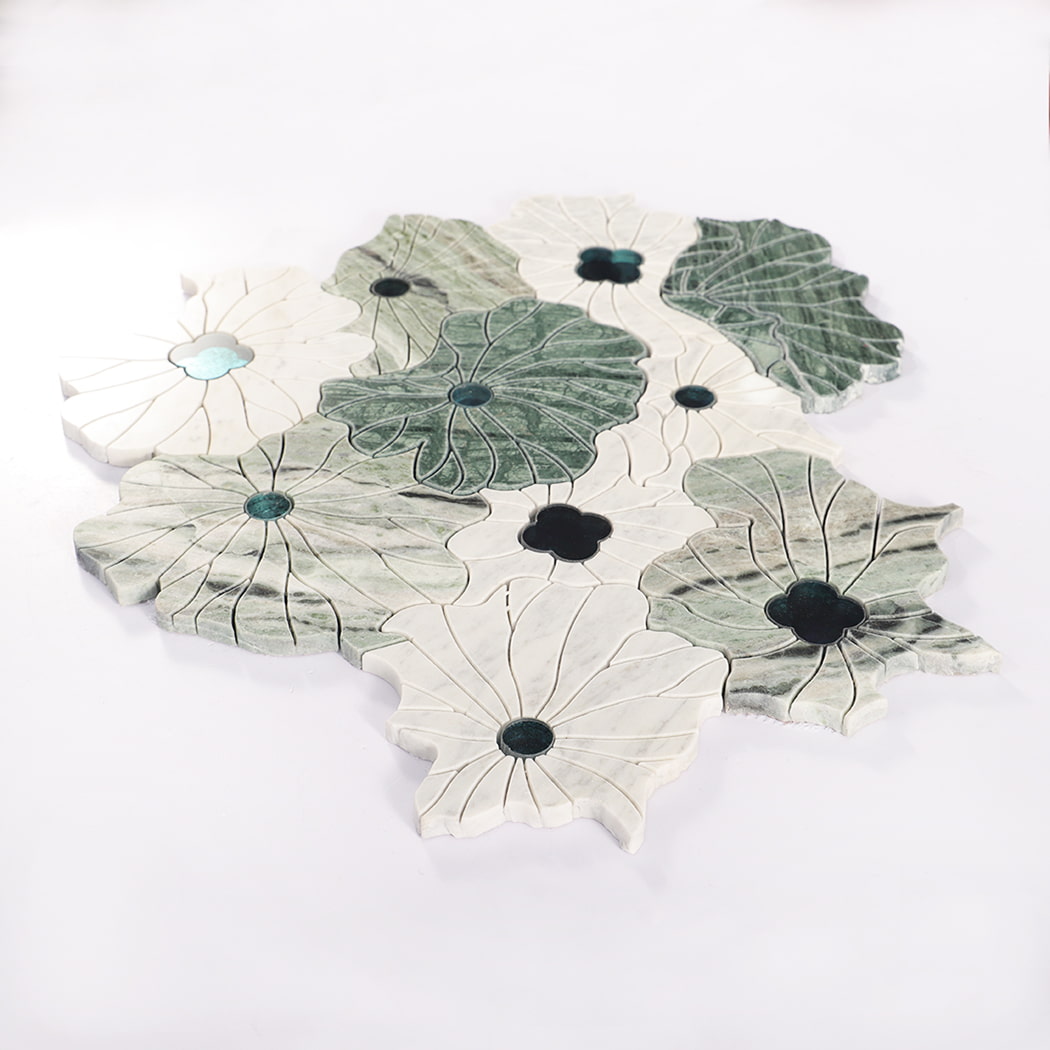 Angled view of green and white flower-shaped marble mosaic tile sheet.