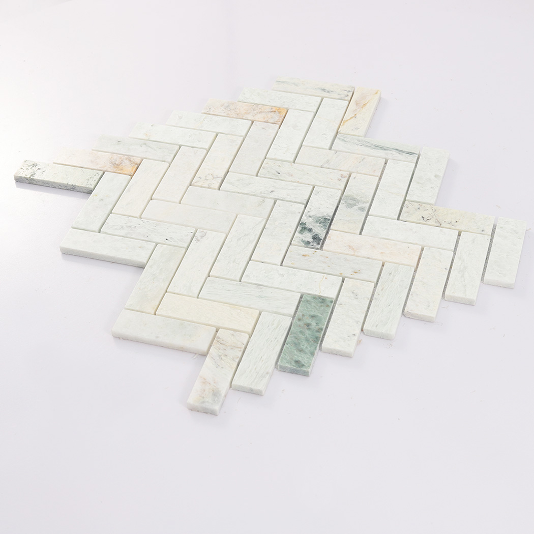 Angled view of light green herringbone marble mosaic tile sheet