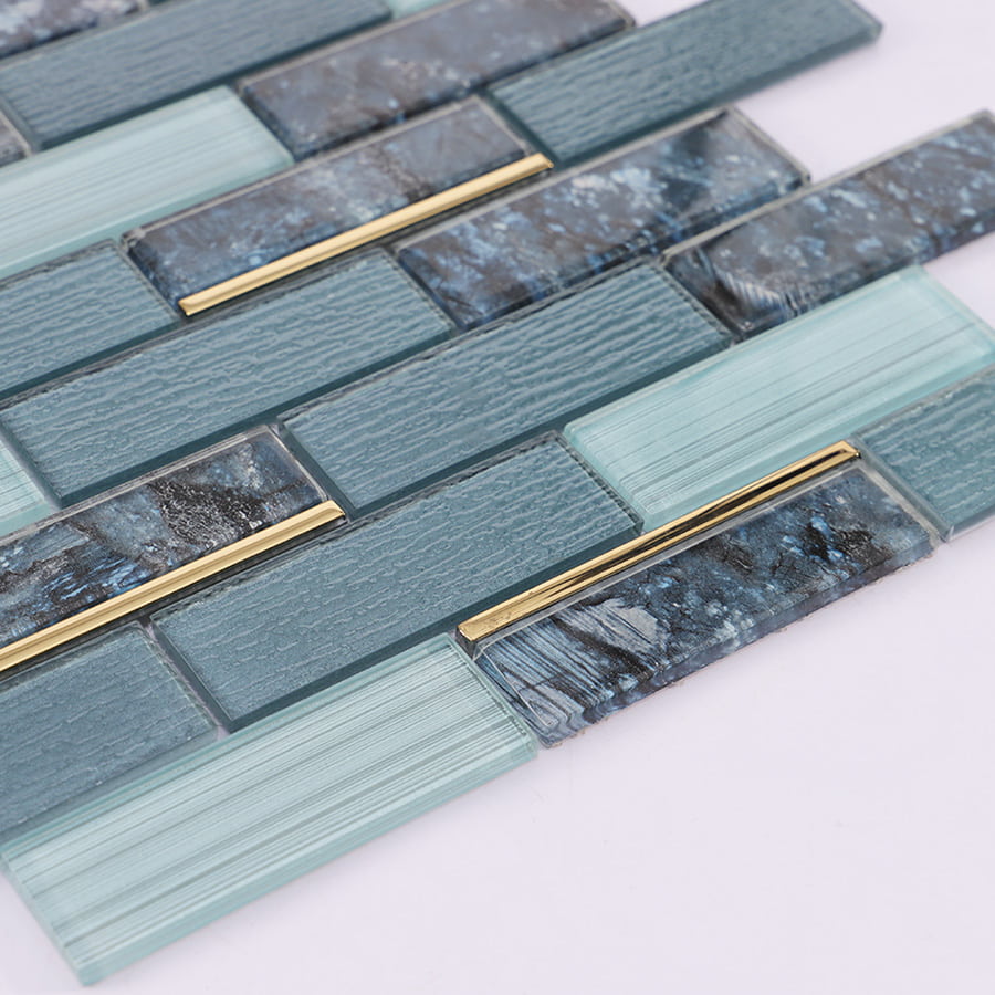 Angled view of blue grey gold line subway glass mosaic tile showing shine and depth
