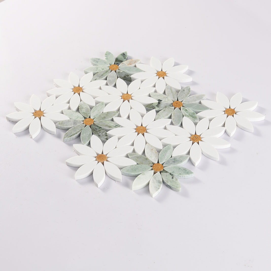Angled view of daisy flower marble mosaic tile sheet with raised petal pieces