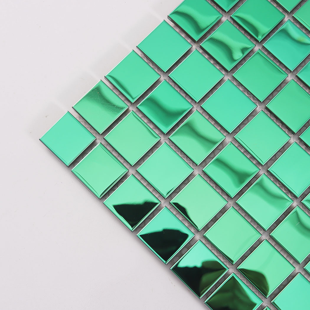 Angled close up of a green metal mosaic sheet corner showing 3D reflective squares.