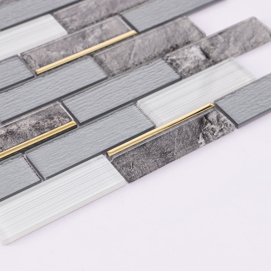 Angled view of grey white gold line subway glass mosaic tile showing reflection