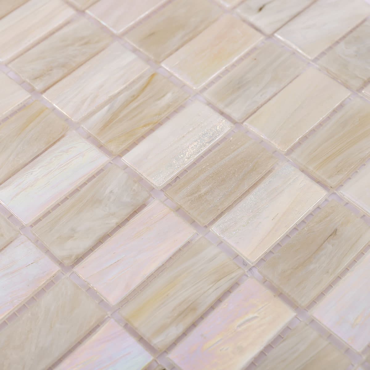 Angled close-up of beige and white iridescent checkered rectangular glass tile