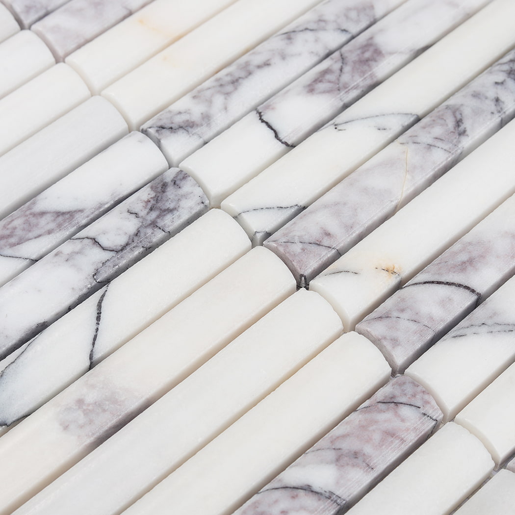 Perspective view of the smooth rounded surface and grey veining of white marble mosaic.