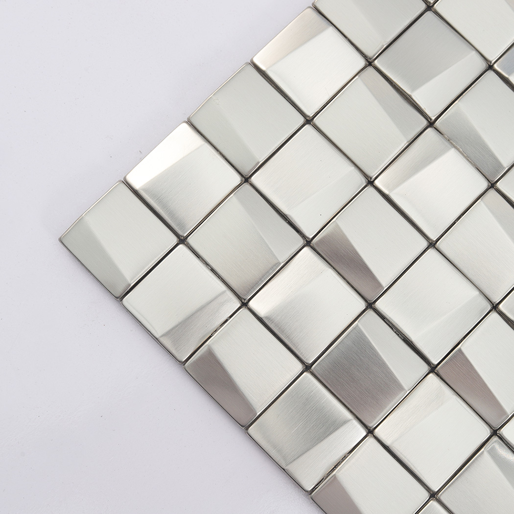 Close-up at an angle showing the 3D relief on small brushed silver stainless tiles.