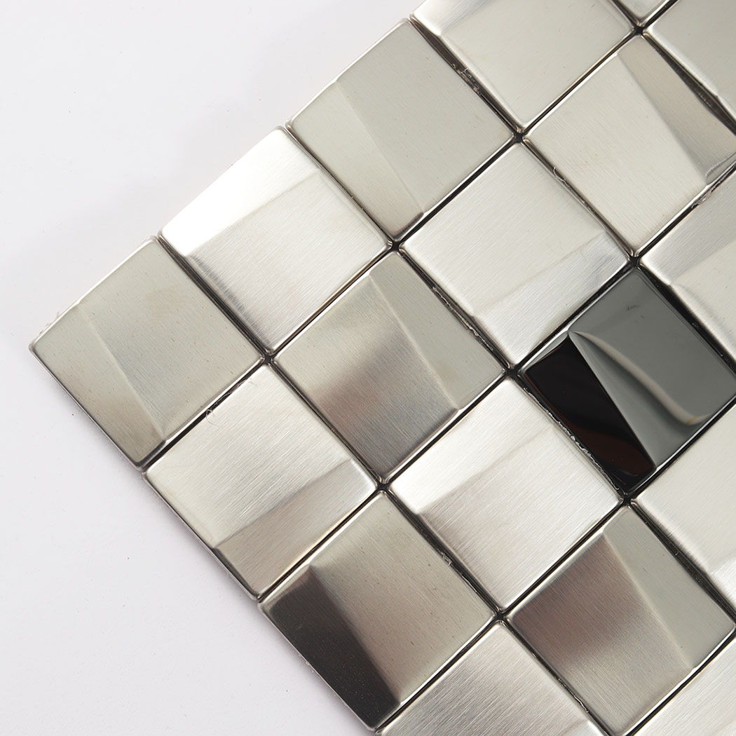Angled close up of a silver metal mosaic sheet corner showing 3D faceted squares.