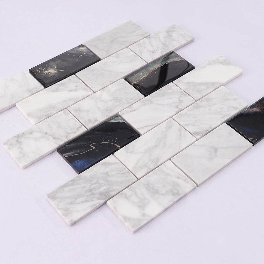 Angled view of white marble and black glass mosaic subway tile sheet