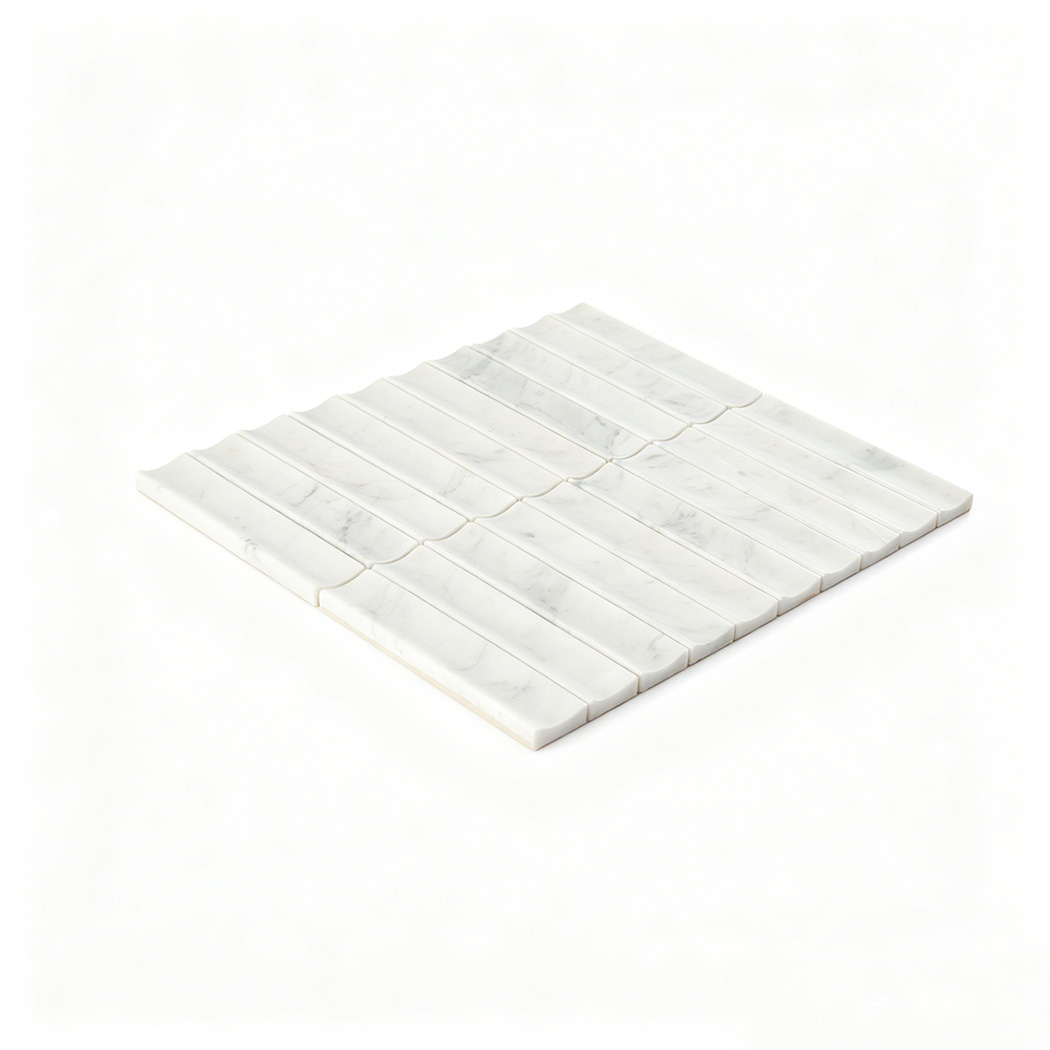 Angled view of white marble curved fluted mosaic tile sheet on white background