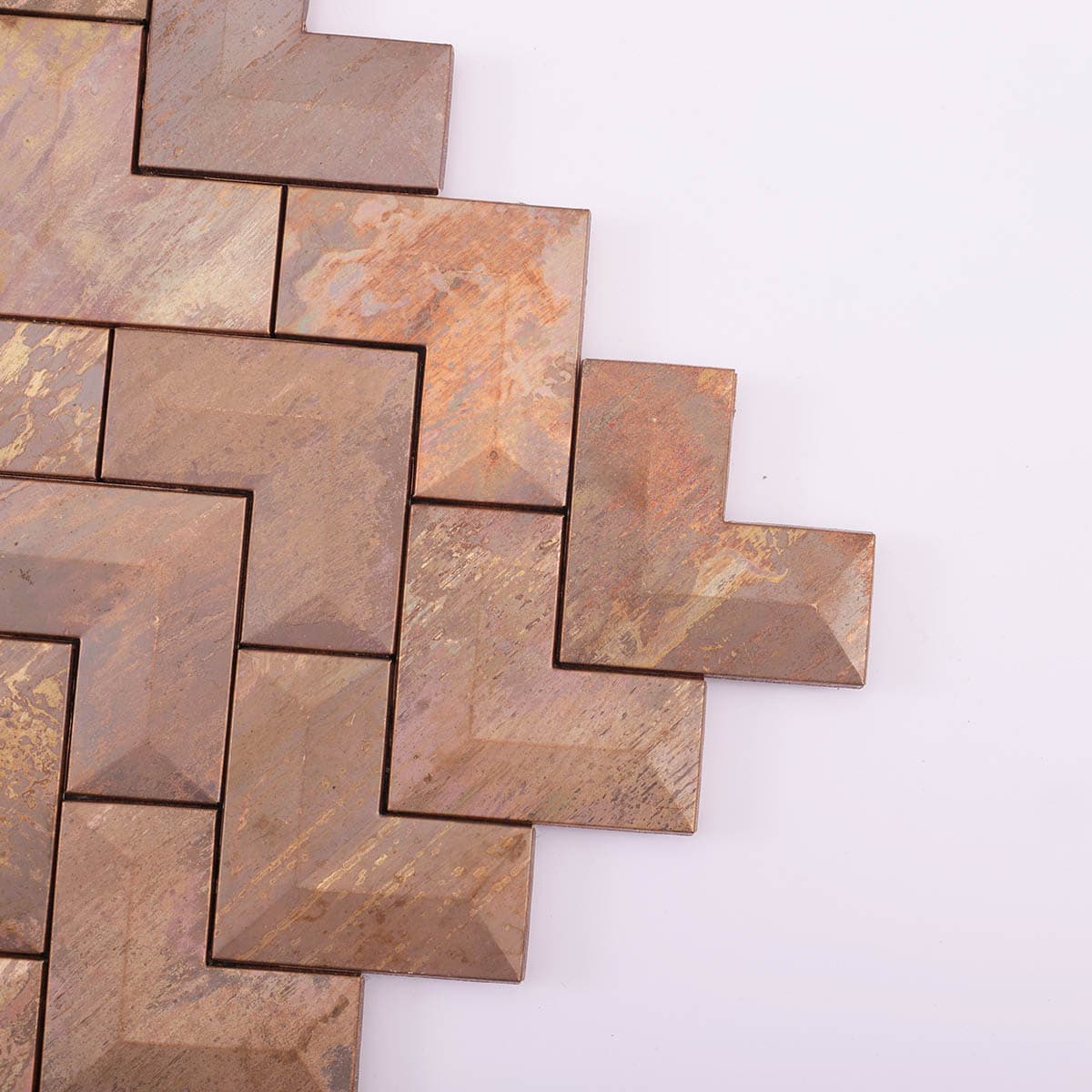 Corner close-up of antique copper metal chevron mosaic