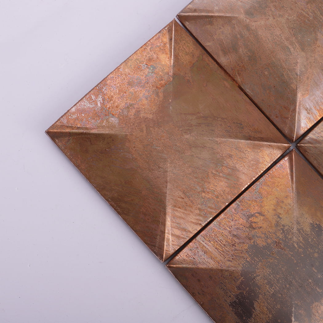 Corner detail close-up of vintage 3D antique copper metal mosaic tile.