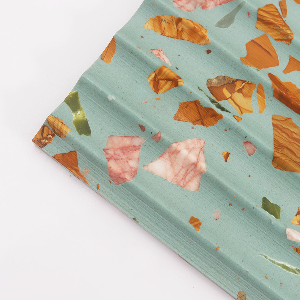Close up of aqua terrazzo fluted tile with pink green and amber chips