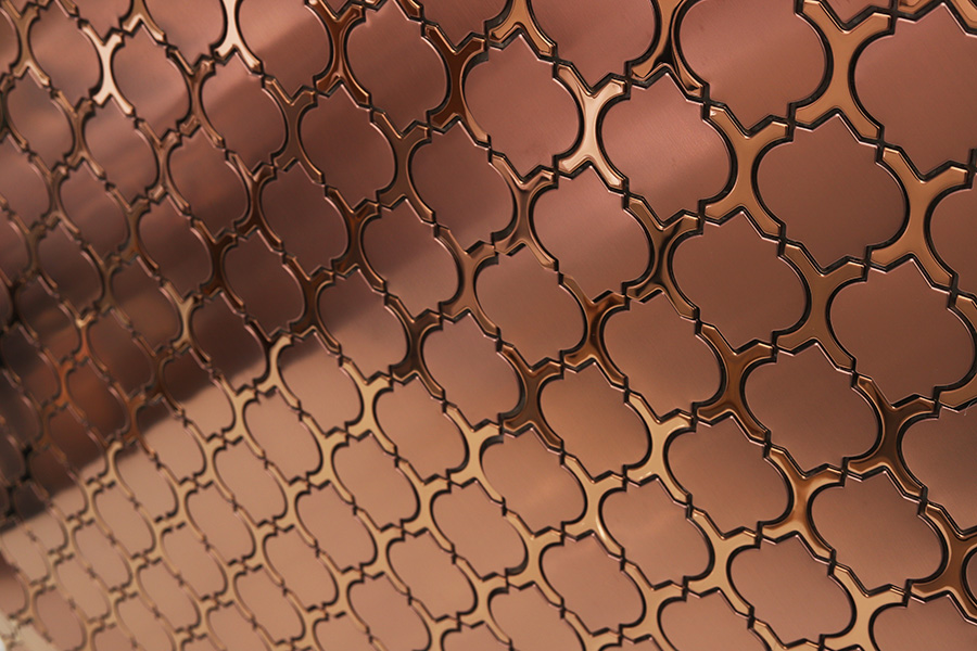 Close-up of geometric rose gold metal Arabesque Backsplash Tiles with a brushed finish.