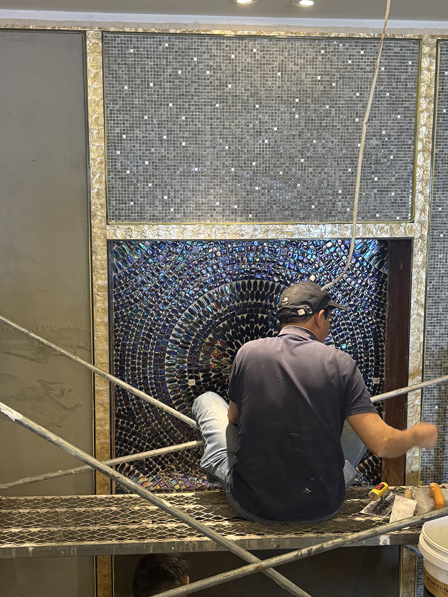 Artisan installing colorful mosaic
