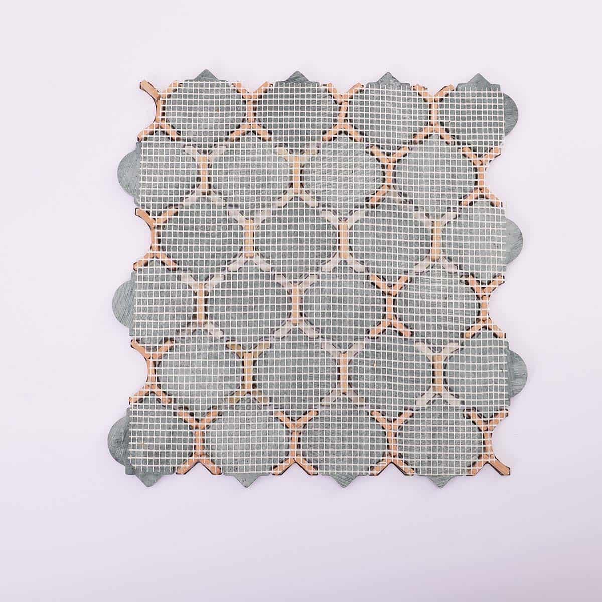 Mesh backing of green marble and gold arabesque tile sheet