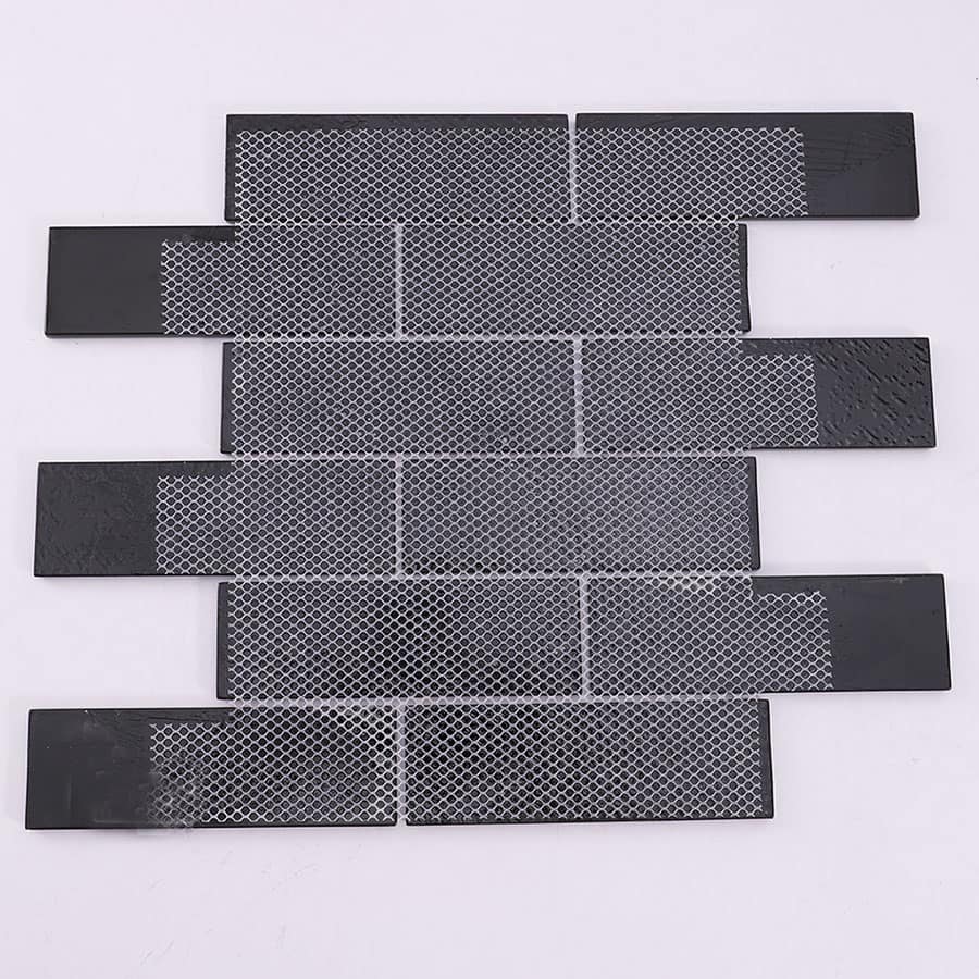 Back side of black and gold glass mosaic tile sheet with mesh backing