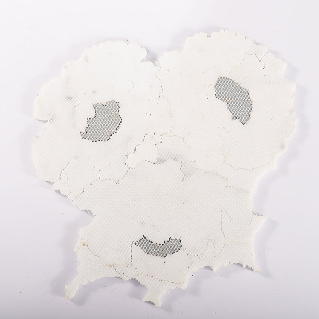 Back view of mesh-mounted white floral marble mosaic tile sheet.