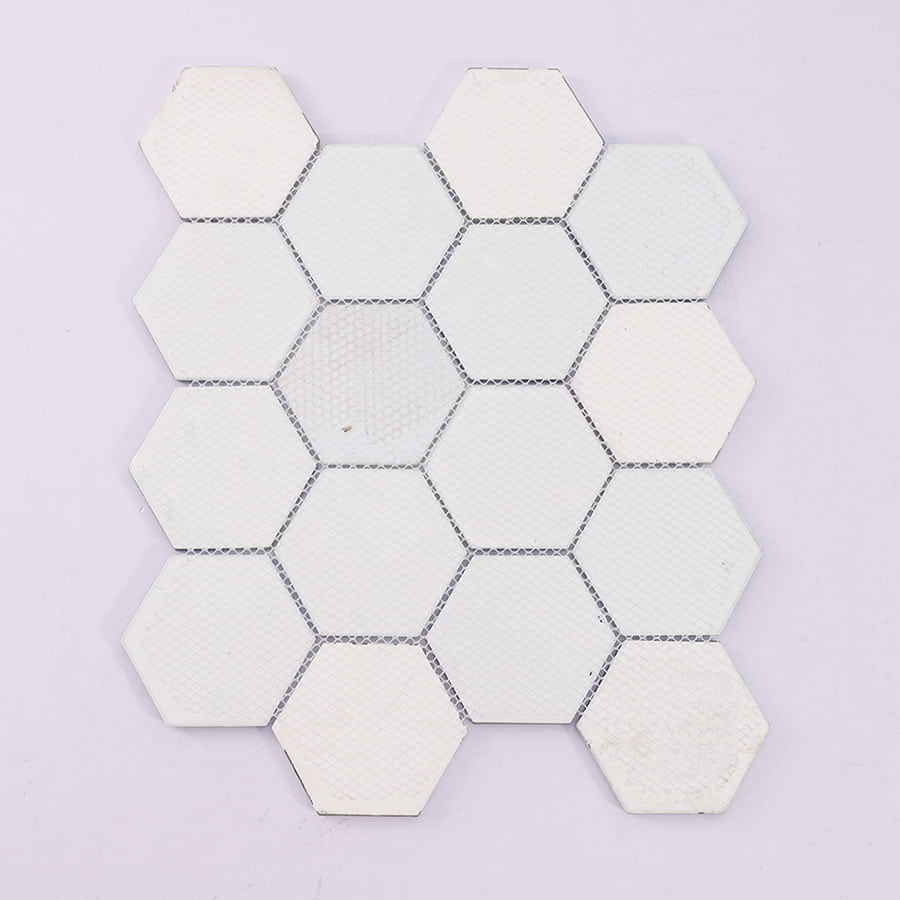 Back side of hexagon glass mosaic tile sheet with mesh backing for installation