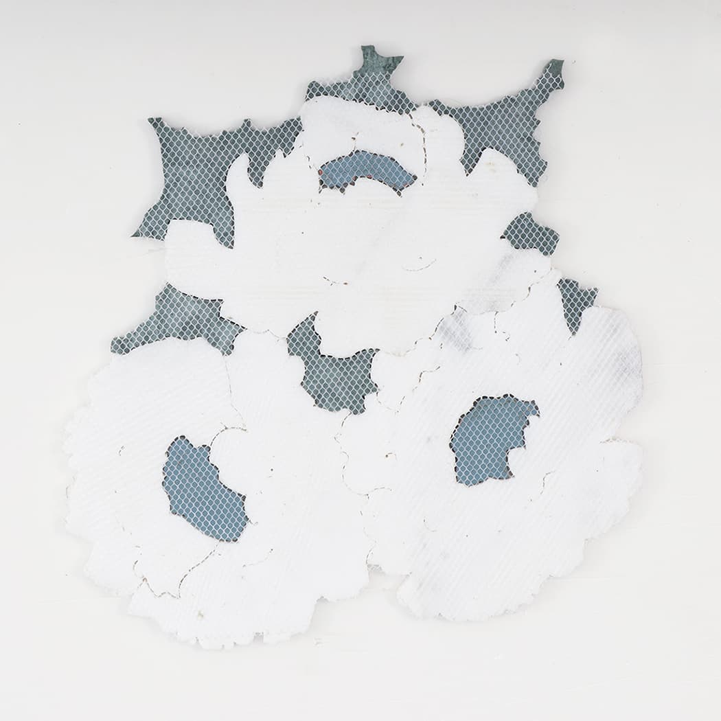 Back view of mesh-mounted white flower marble mosaic tile sheet.