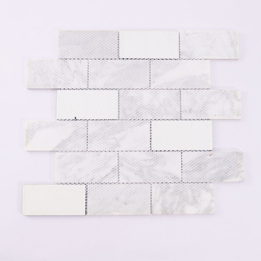Back side of white marble and black glass mosaic tile sheet with mesh backing