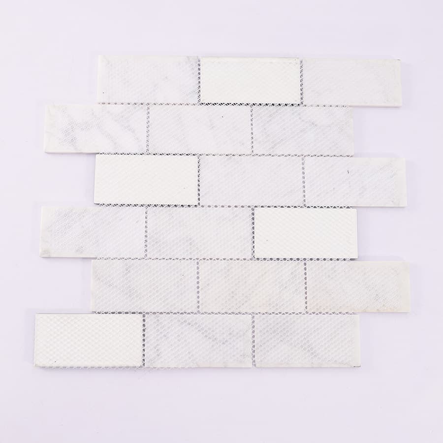 Back side of white marble and green glass mosaic tile sheet with mesh backing