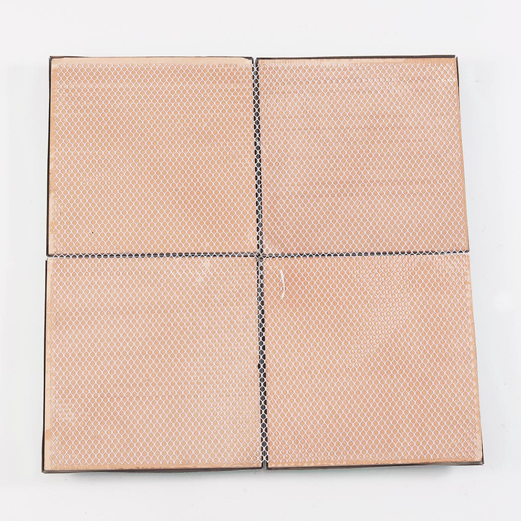 Back view of four wall tiles showing the convenient mesh backing.