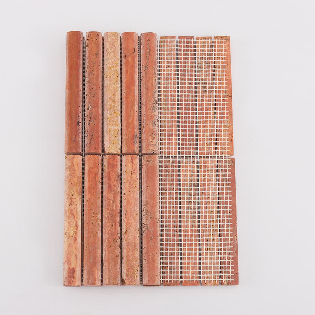 Image showing the white mesh backing on a partially folded red travertine mosaic sheet.
