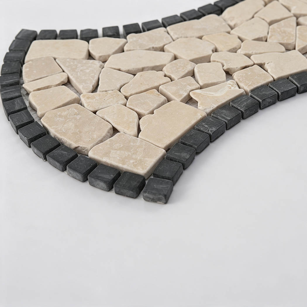 Angled view showing beige marble pebbles and raised dark charcoal border tiles