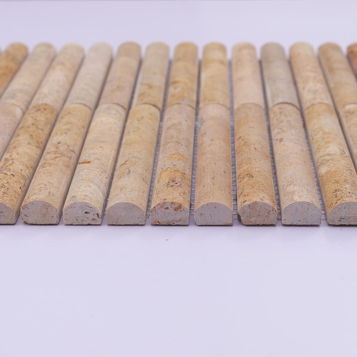 End view showing rounded curve of travertine fluted tiles