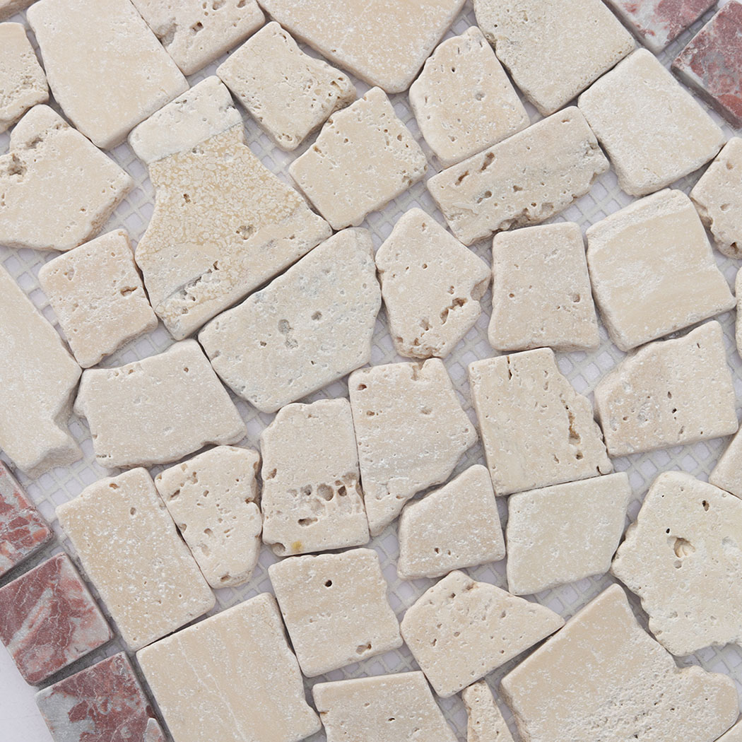 Surface detail of beige irregular marble pebble mosaic with natural stone pits