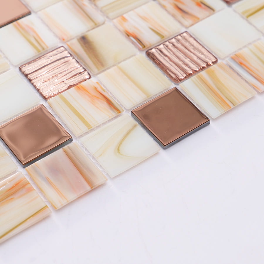 Angled view of mosaic tile sheet with rose gold glossy accents