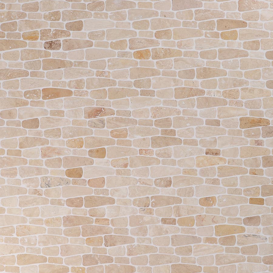Close-up of beige stone mosaic tiles with irregular brick pattern