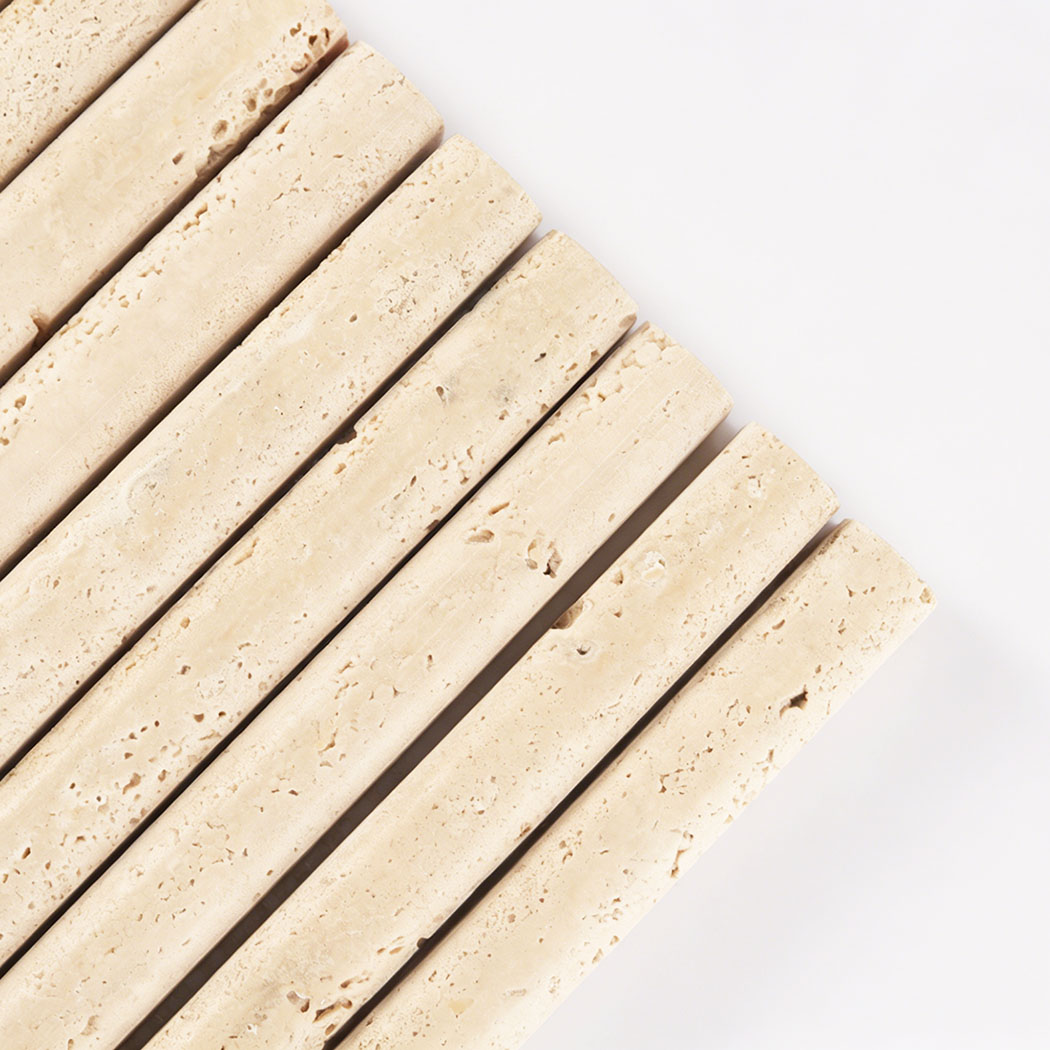 Close up of beige travertine curved linear mosaic tile with natural holes