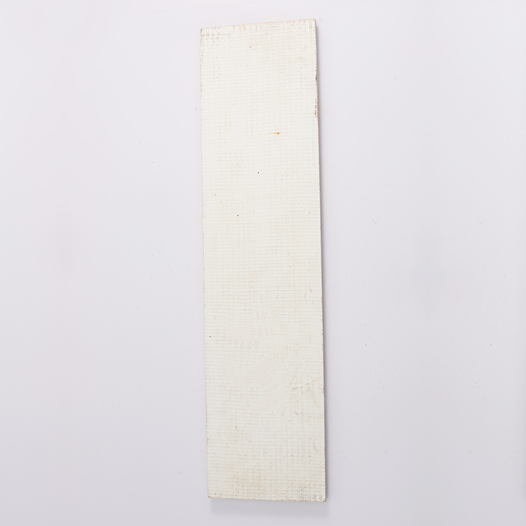 Back view of beige travertine fluted tile with flat textured backing