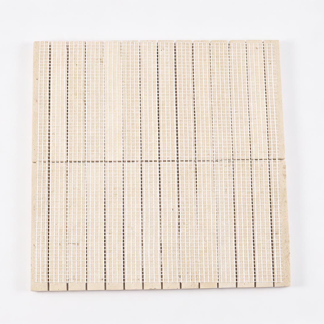 Back view of beige travertine linear mosaic tile sheet with white mesh backing