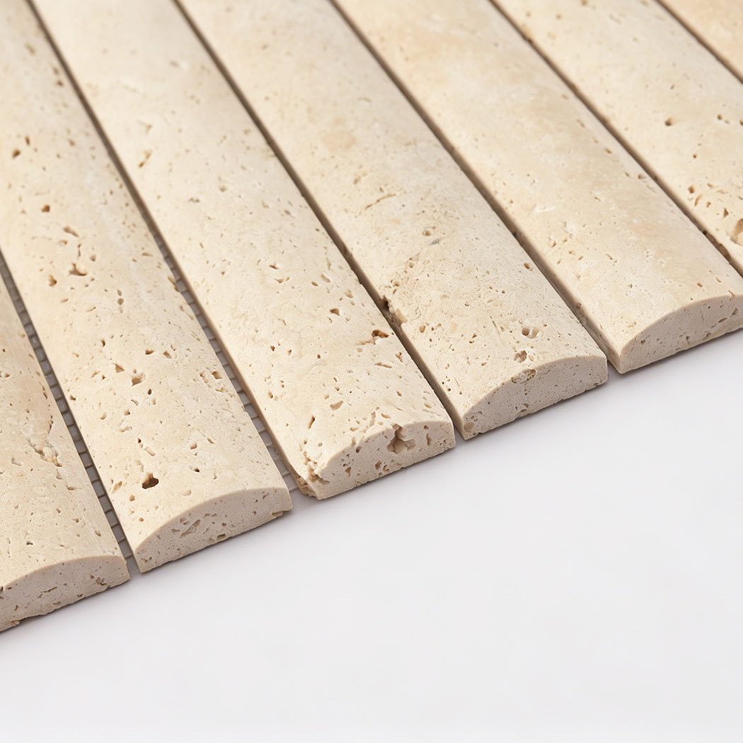 Side view of beige travertine raised bar tile showing thick curved profile