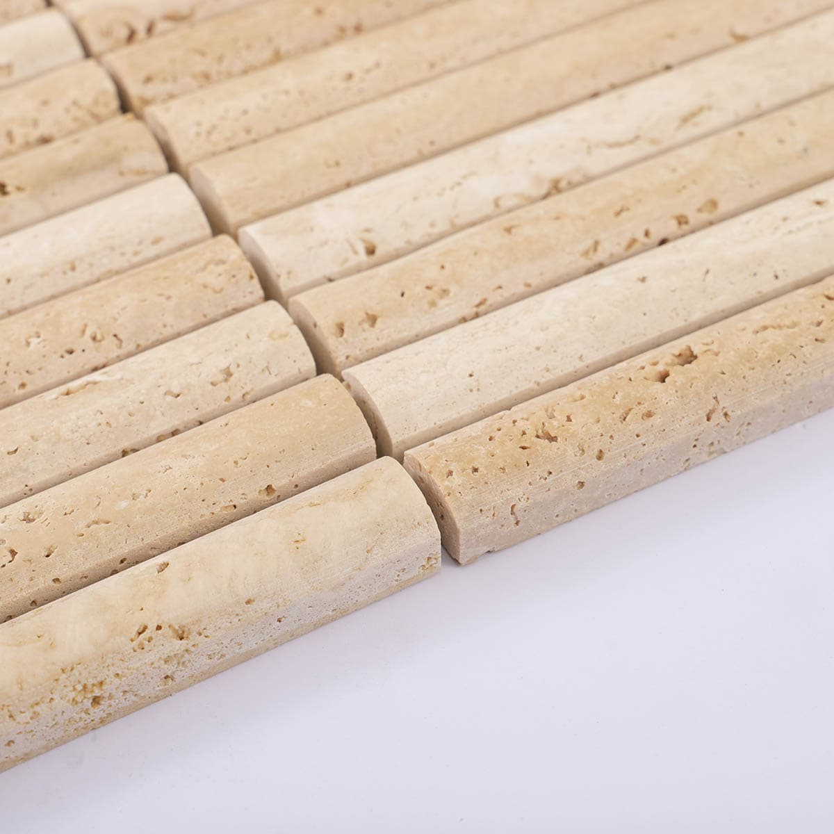 Edge angle close-up of beige travertine stick mosaic