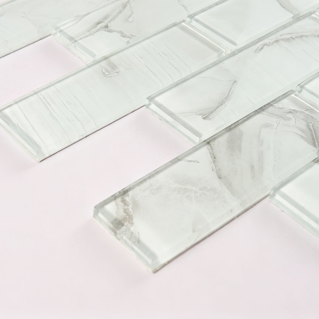 Angled close up of white gray glass subway tile with soft marble veins
