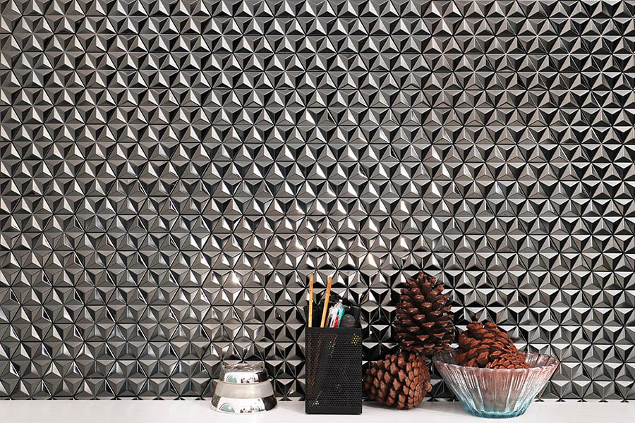 Black 3D pyramid stainless steel tile splashback with reflective geometric texture