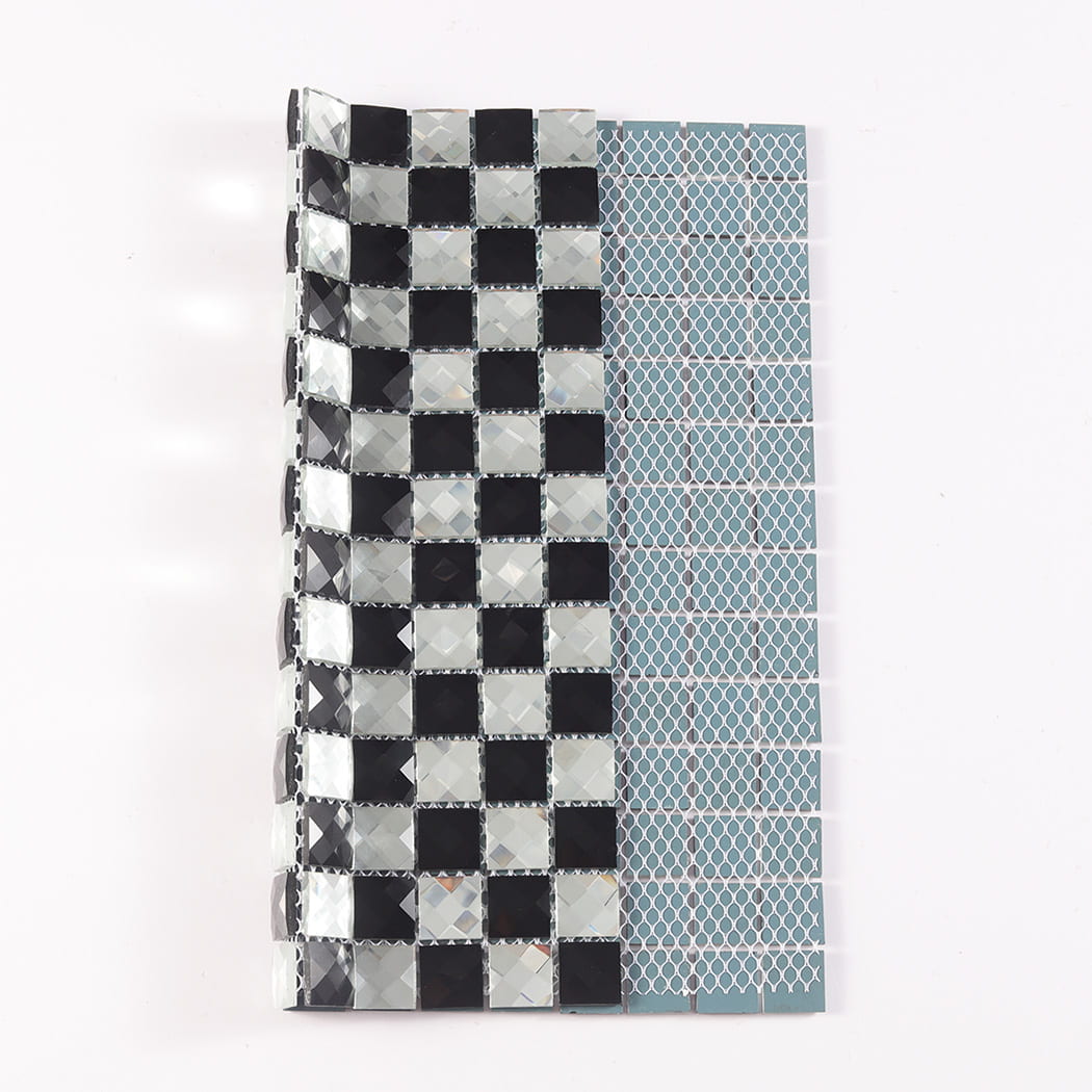 Black and silver mirror mosaic tile folded to show the front design and mesh backing.