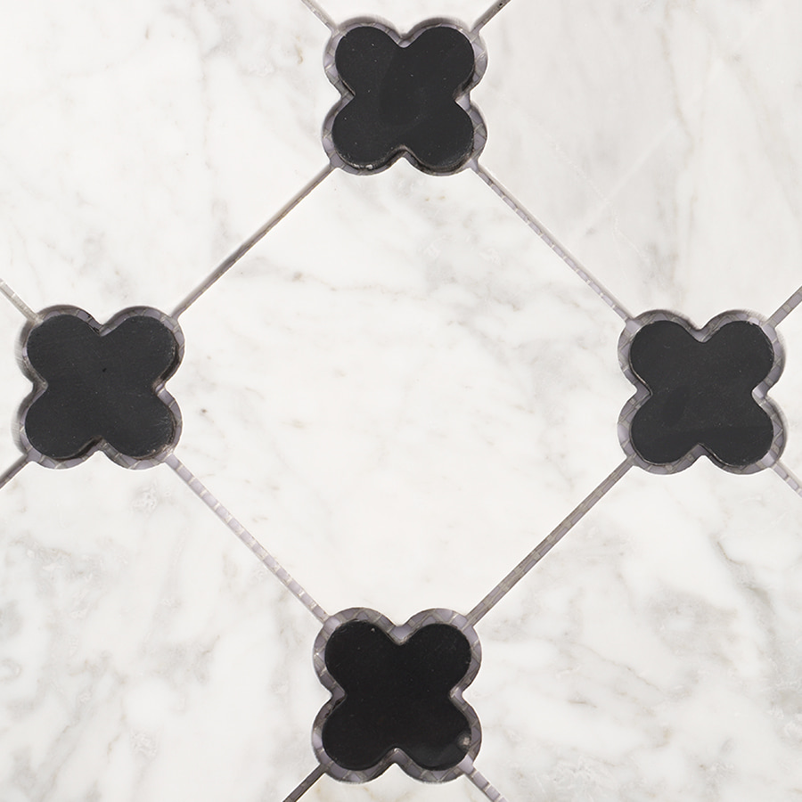Detailed view of black and white clover marble mosaic pattern.