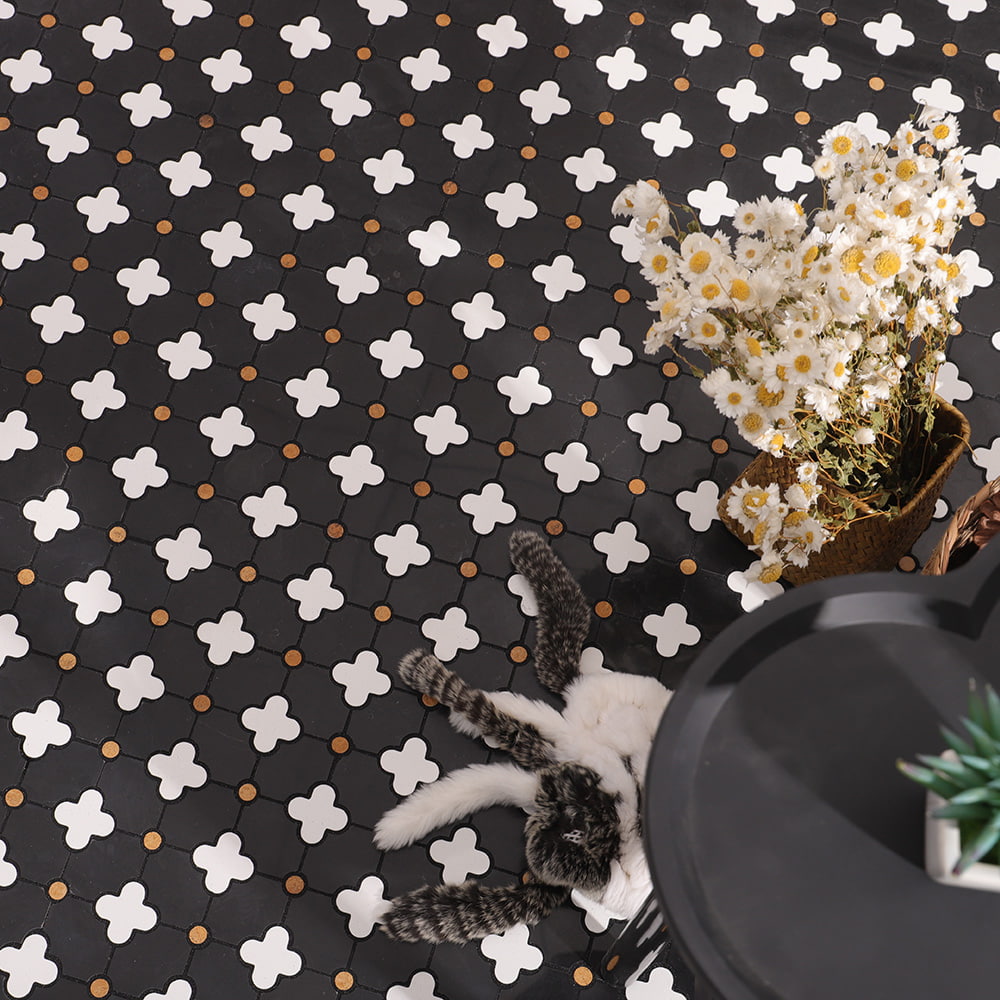 Black and white clover pattern floor tile with floral decor and cozy setting